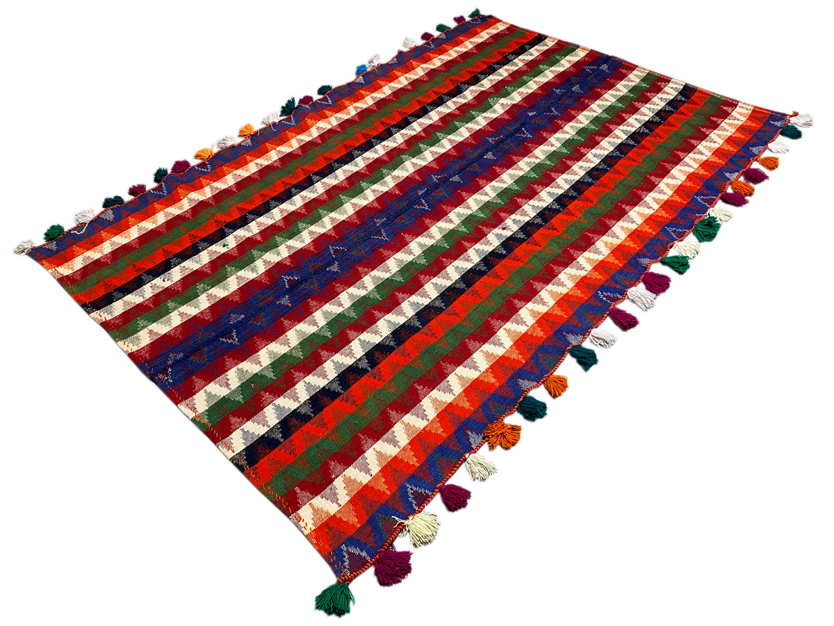 Multicolored striped rug with tassels, rectangular, diagonal view of the edges