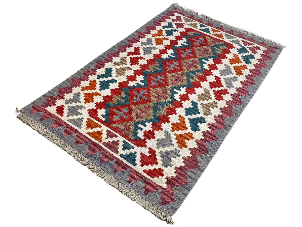 Rectangular kilim rug with a geometric pattern in red, blue, green, and beige