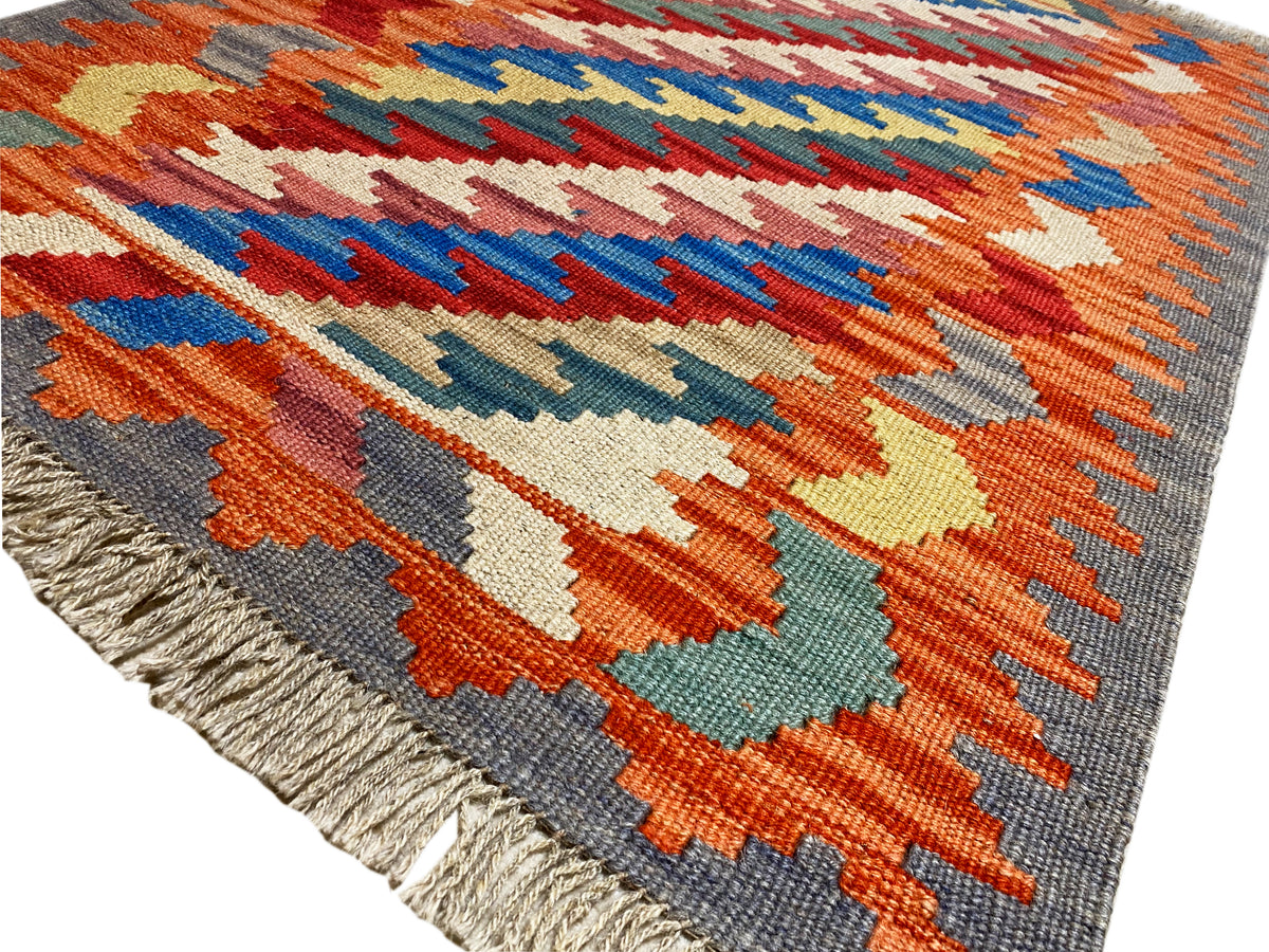 Kilim Qashqai rug with colorful patterned panels and a gray border; fringes, 121x78 cm