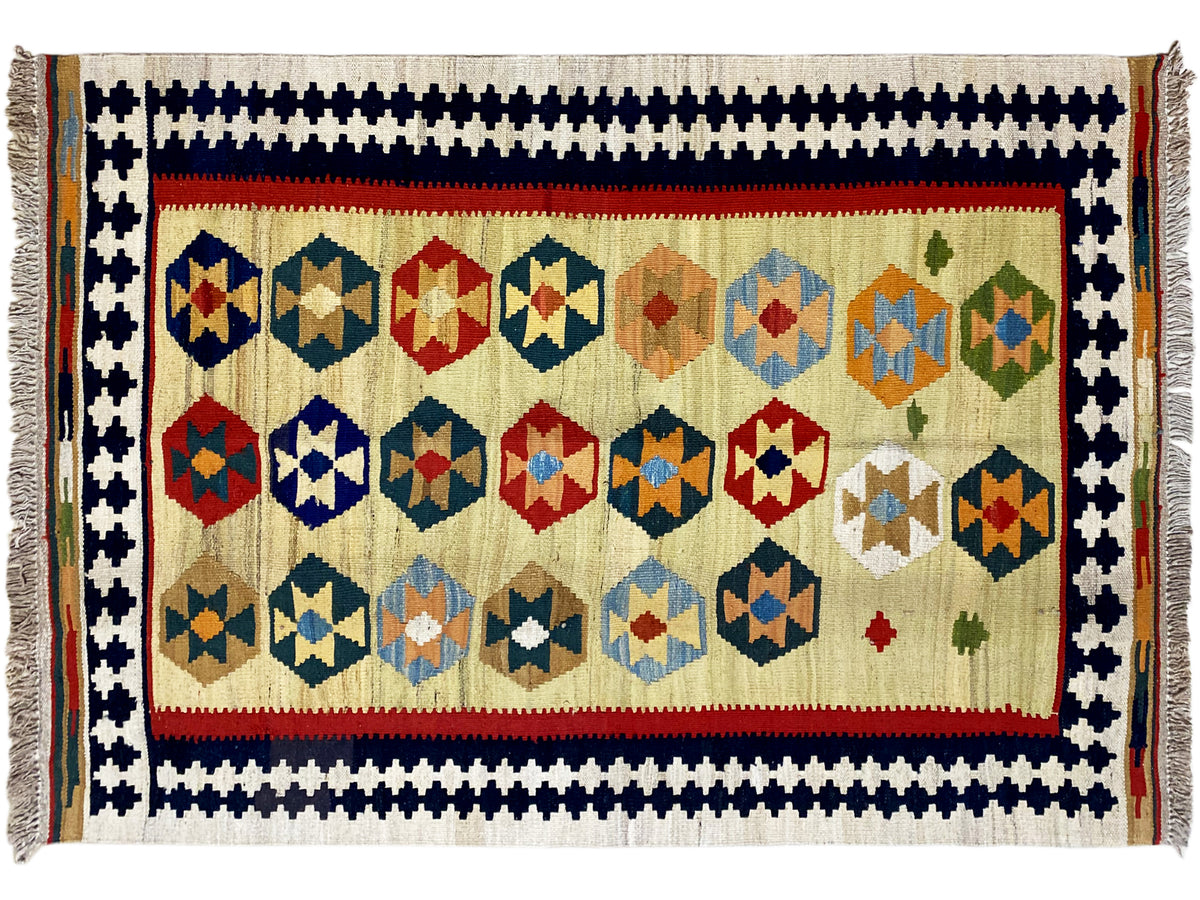 Kelim Qashqai rug in beige with a rectangular patterned field, decorative border and fringes