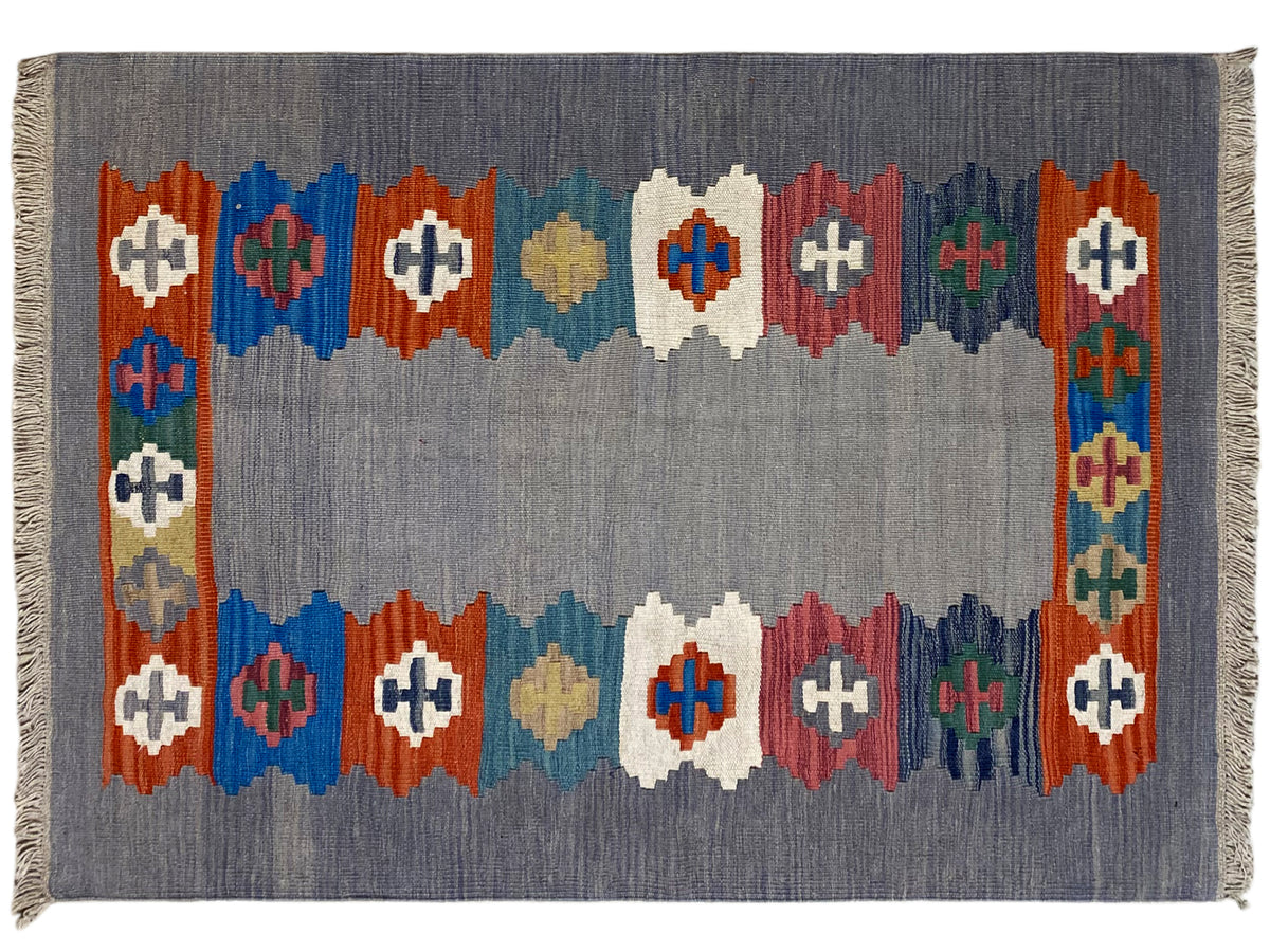 Gray mélange Kilim rug with an all-around diamond border and colorful motifs
