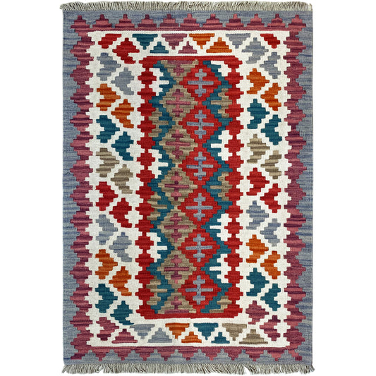 View of a kilim rug with a central ornamental design and colorful diamond shapes