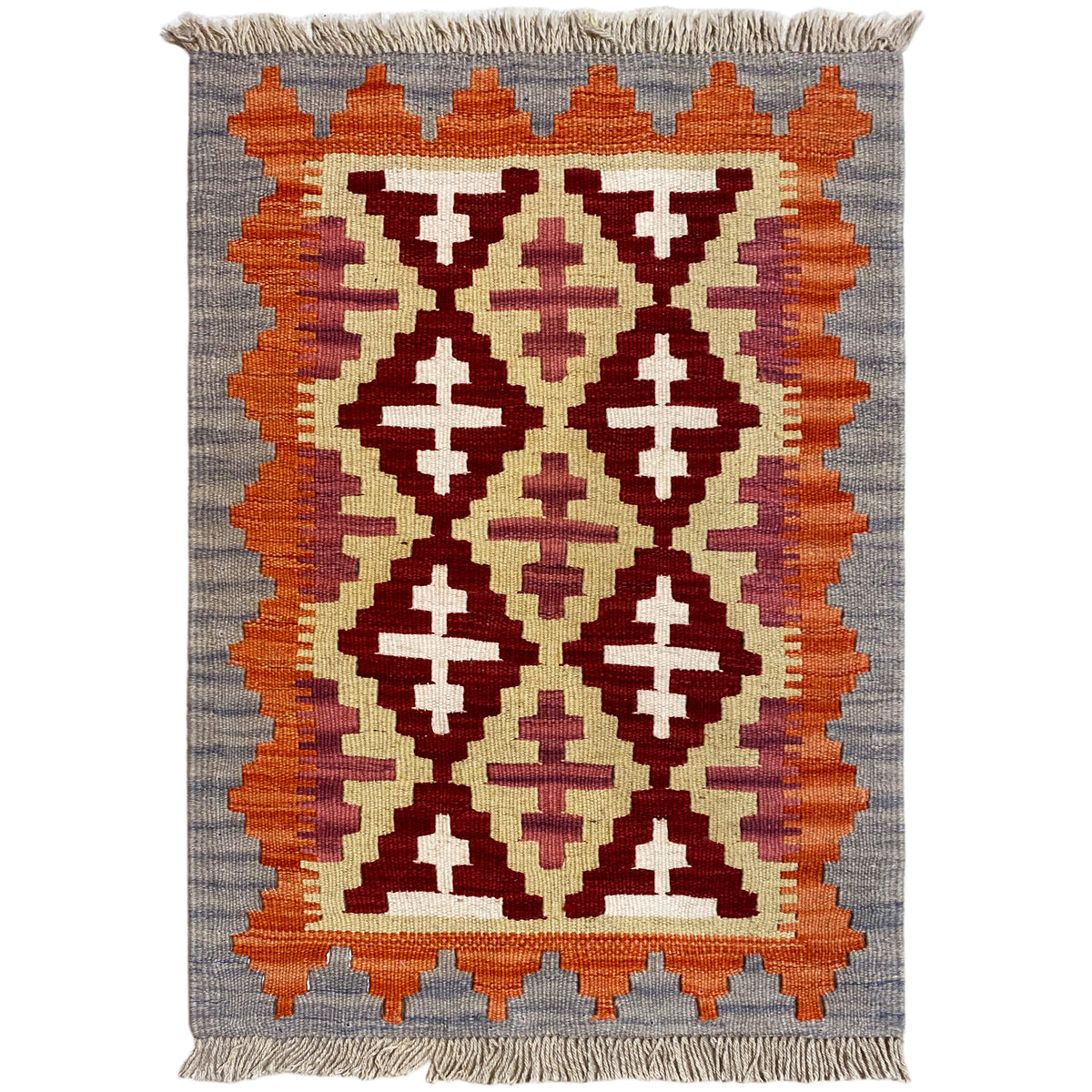 Rectangular kilim rug with geometric patterns in orange, cream, and dark red