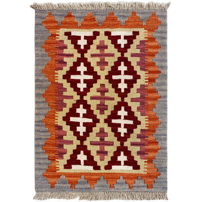 Rectangular kilim rug with geometric patterns in orange, cream, and dark red