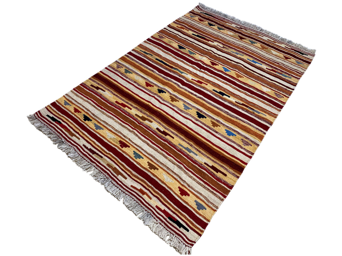 Kilim rug with horizontal stripes and color motifs, fringed edges visible