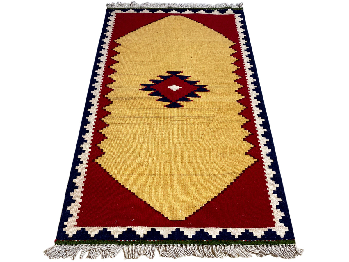 Kilim rug in portrait orientation: yellow field, red border areas, and dark border