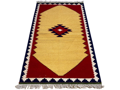 Kilim rug in portrait orientation: yellow field, red border areas, and dark border