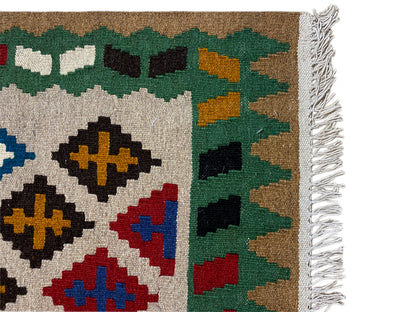 Kilim Qashqai rug, detail of the weave structure with fringes and green elements along the edge