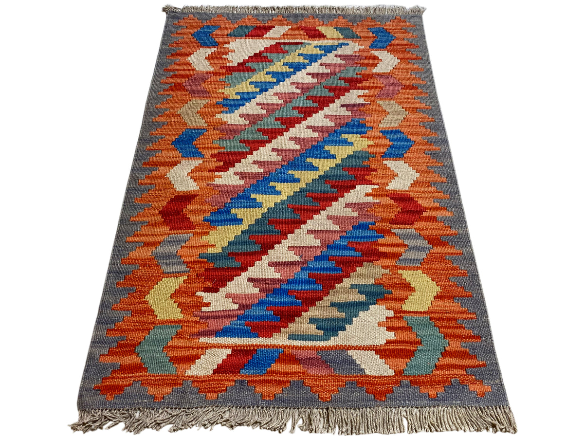 Kelim Qashqai rug with a chevron pattern in orange, blue and cream; gray border, 121x78 cm