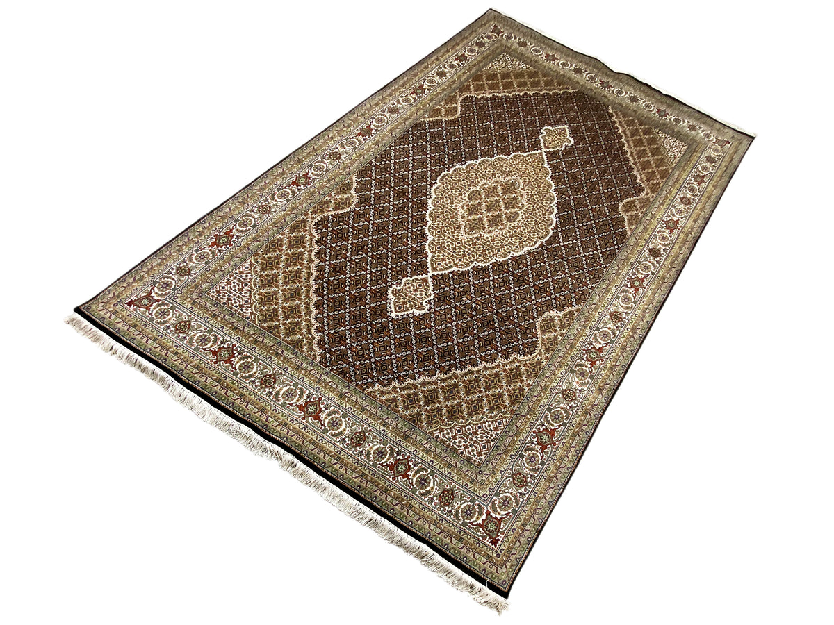 Brown Indo-Tabriz rug with a central medallion, diamond lattice and border, fringes.