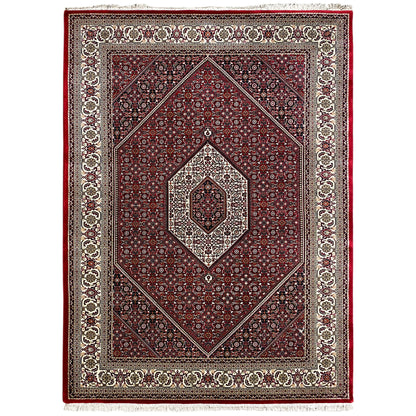 Reddish-brown carpet with a symmetrical ornamental pattern, central medallion, and border