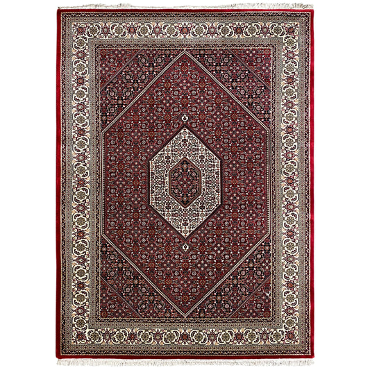 Reddish-brown carpet with a symmetrical ornamental pattern, central medallion, and border