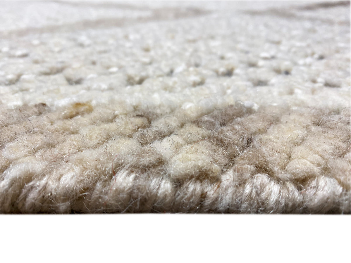 Berber rug close-up of the pile: light beige fibers with short shading variations