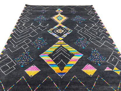Black designer rug with abstract diamond and zigzag patterns in color