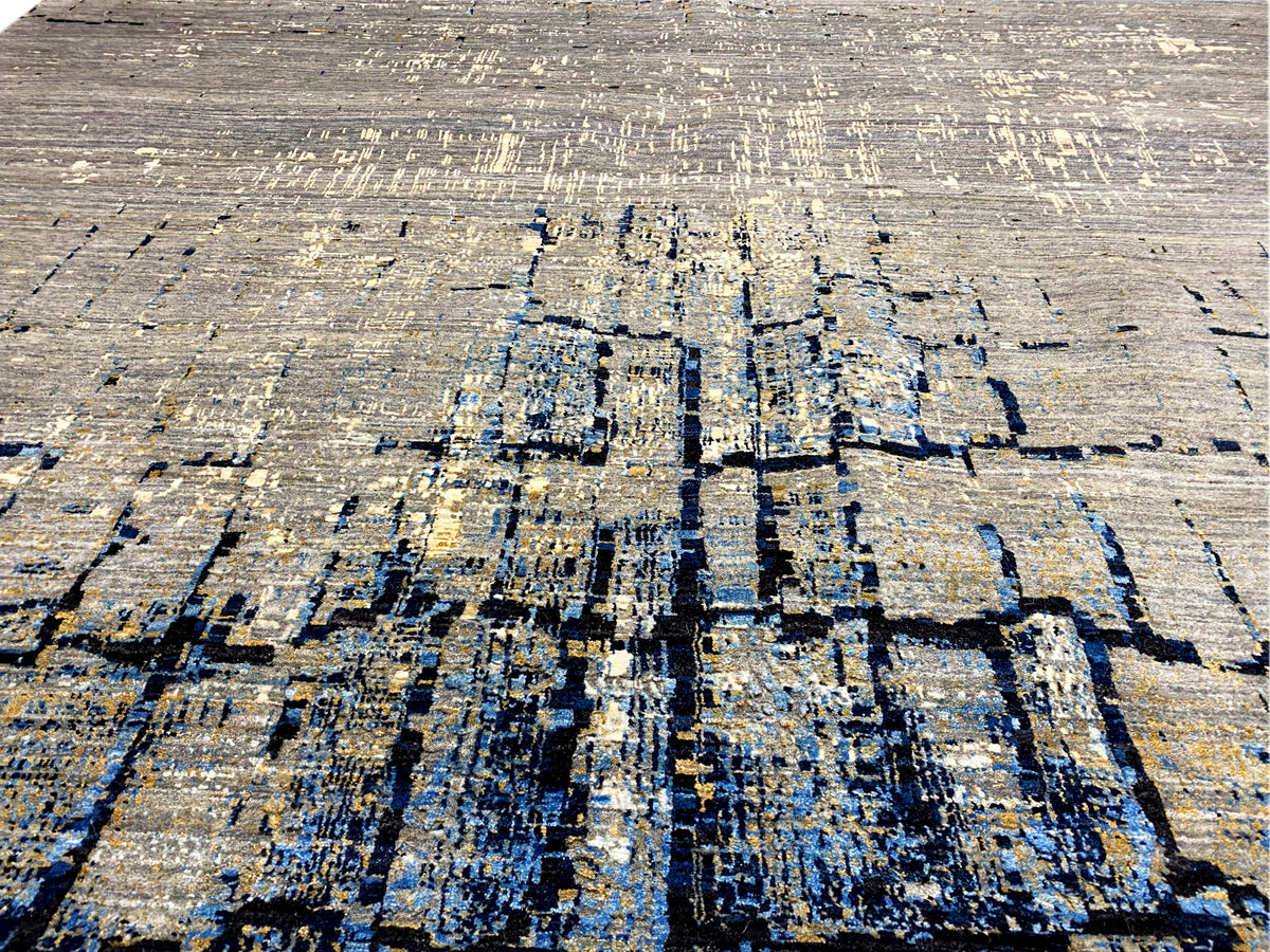 Hand-knotted rug close-up: abstract blue-gray block pattern