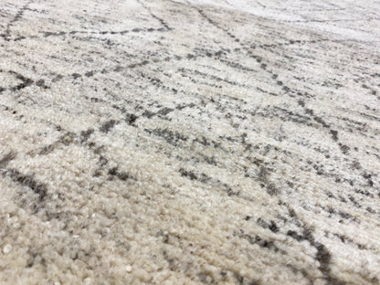 Close-up: Berber rug with mottled pile and dark gray linear pattern