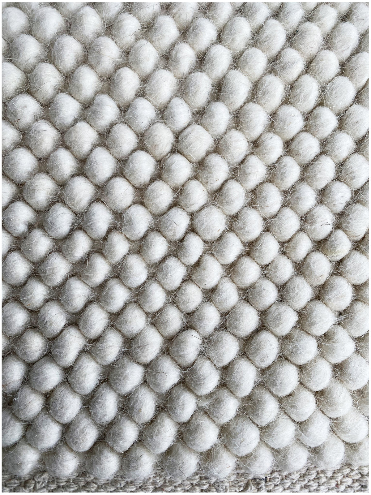 Carpet, close-up: felt nubs in a shingle pattern, light gray/white