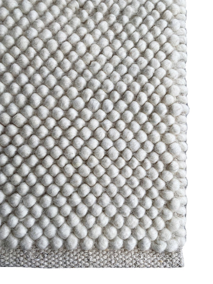 Rug, edge detail: fine wool pile with a ball texture, light gray/white