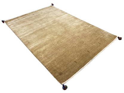 Light brown Gabbeh rug with a white border and blue tassels at the corners