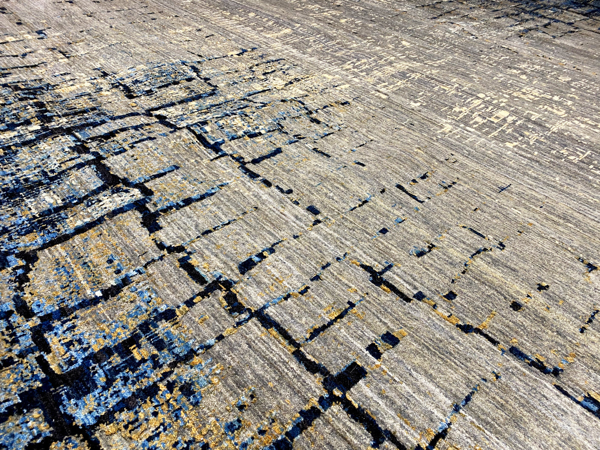 Hand-knotted rug with diagonal lines and blue-and-gold accent fields