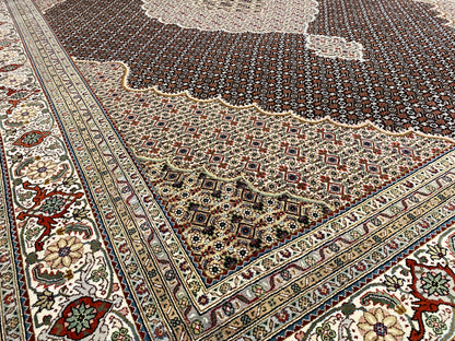 Corner of a dark brown rug with an ornamental border and floral details