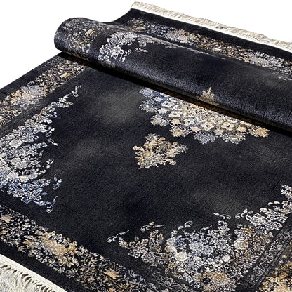 Detail of the carpet surface with dark fabric and ornaments in silver, gold, and blue