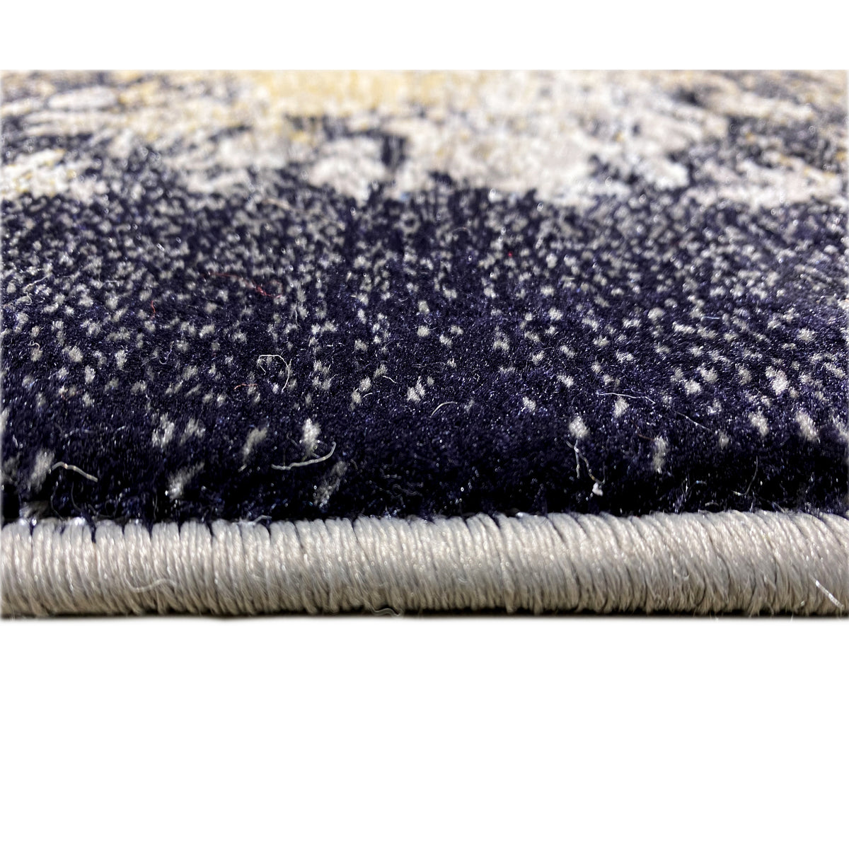 Black rug with blue-gray patterns and fringes along the edge