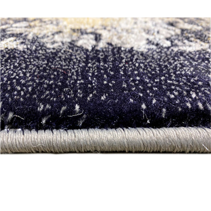 Black rug with blue-gray patterns and fringes along the edge