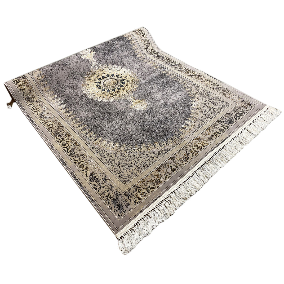 Rug in angled view with medallion, mottled gray, gold lines and fringe