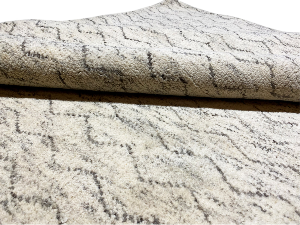 Berber rug detail: short-pile texture, light beige with gray lines in the pattern