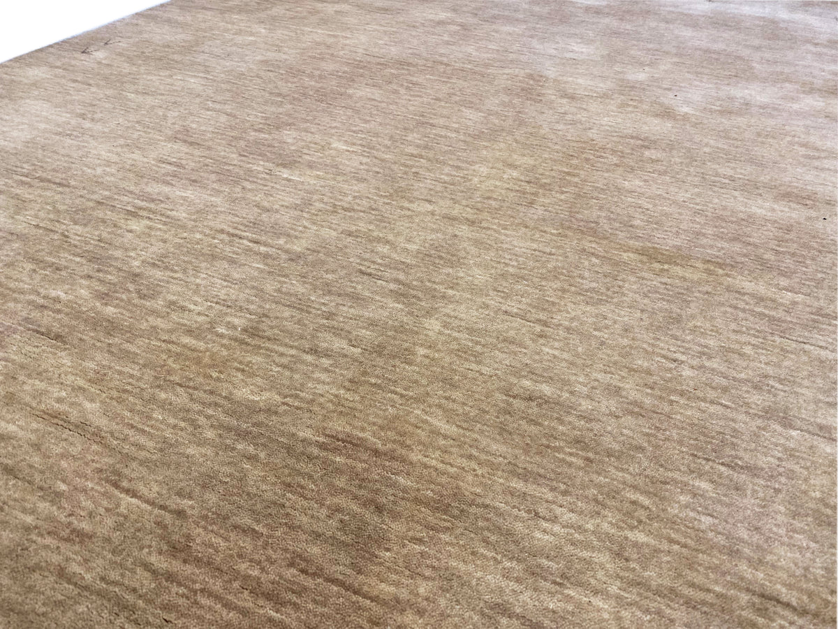 Light brown Gabbeh rug with a fine, mottled weave and slightly aged appearance