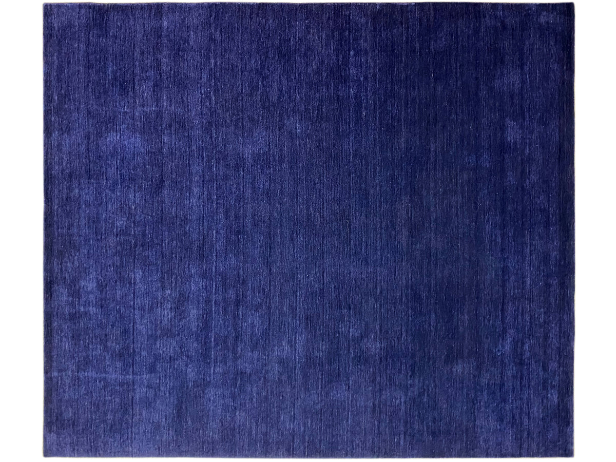 Blue rectangular rug with an even, subtly textured surface.