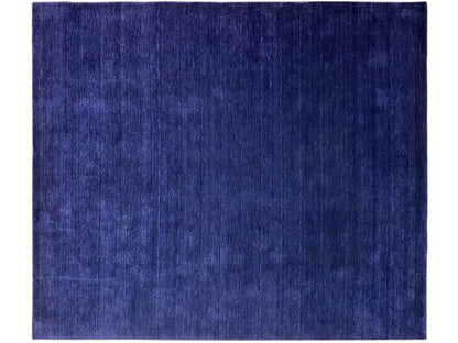 Blue rectangular rug with an even, subtly textured surface.