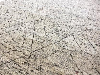 Close-up: light beige Berber rug with fine dark gray lines and a woven texture