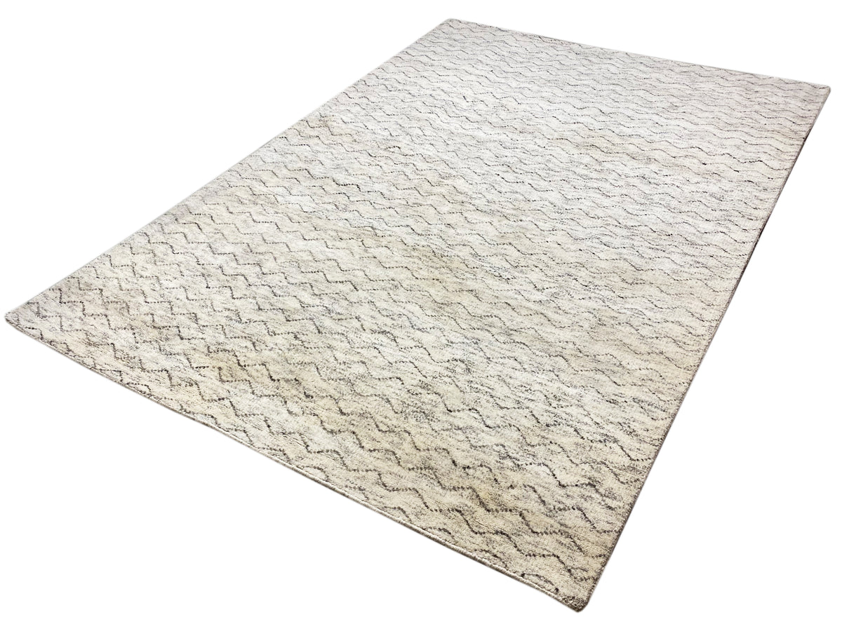 Rectangular Berber rug with a light beige surface and zigzag wave pattern