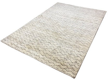 Rectangular Berber rug with a light beige surface and zigzag wave pattern