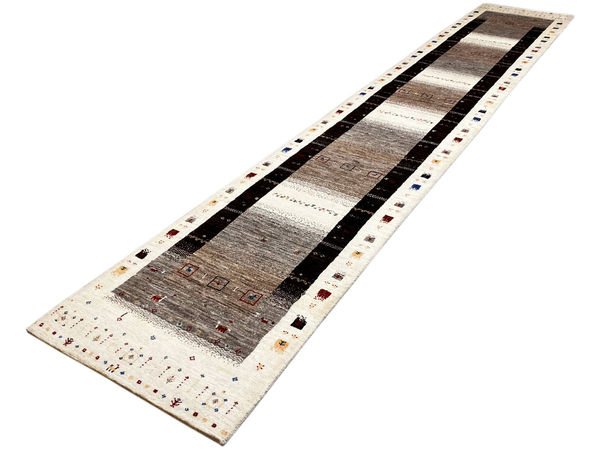 Gabbeh runner on a white background: beige, gray, and black with multicolored border decoration