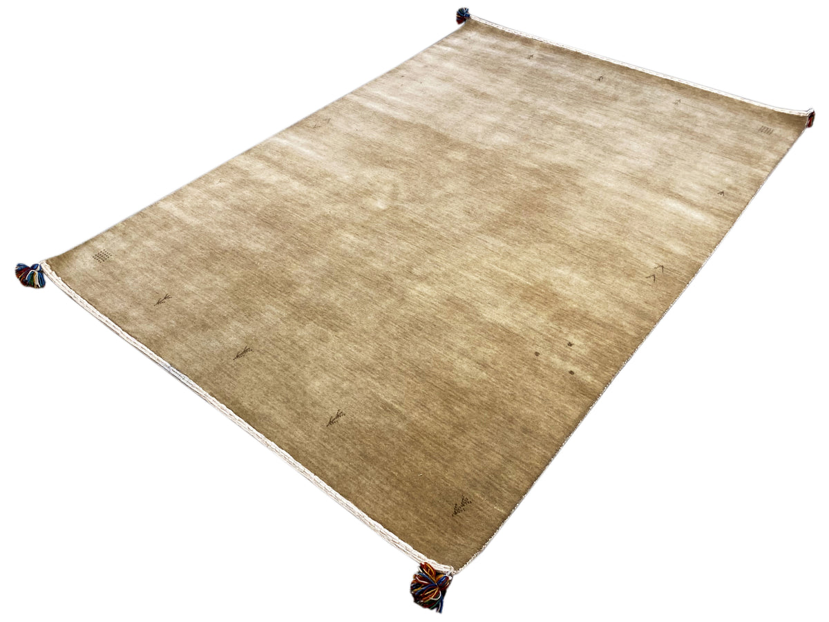 Light brown Gabbeh rug with a white border and blue tassels, large-scale view