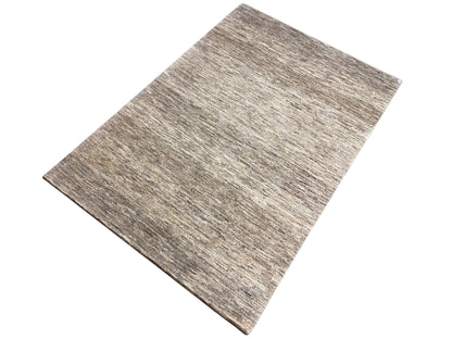 Rectangular Gabbeh rug, photographed diagonally, mottled gray-brown finish