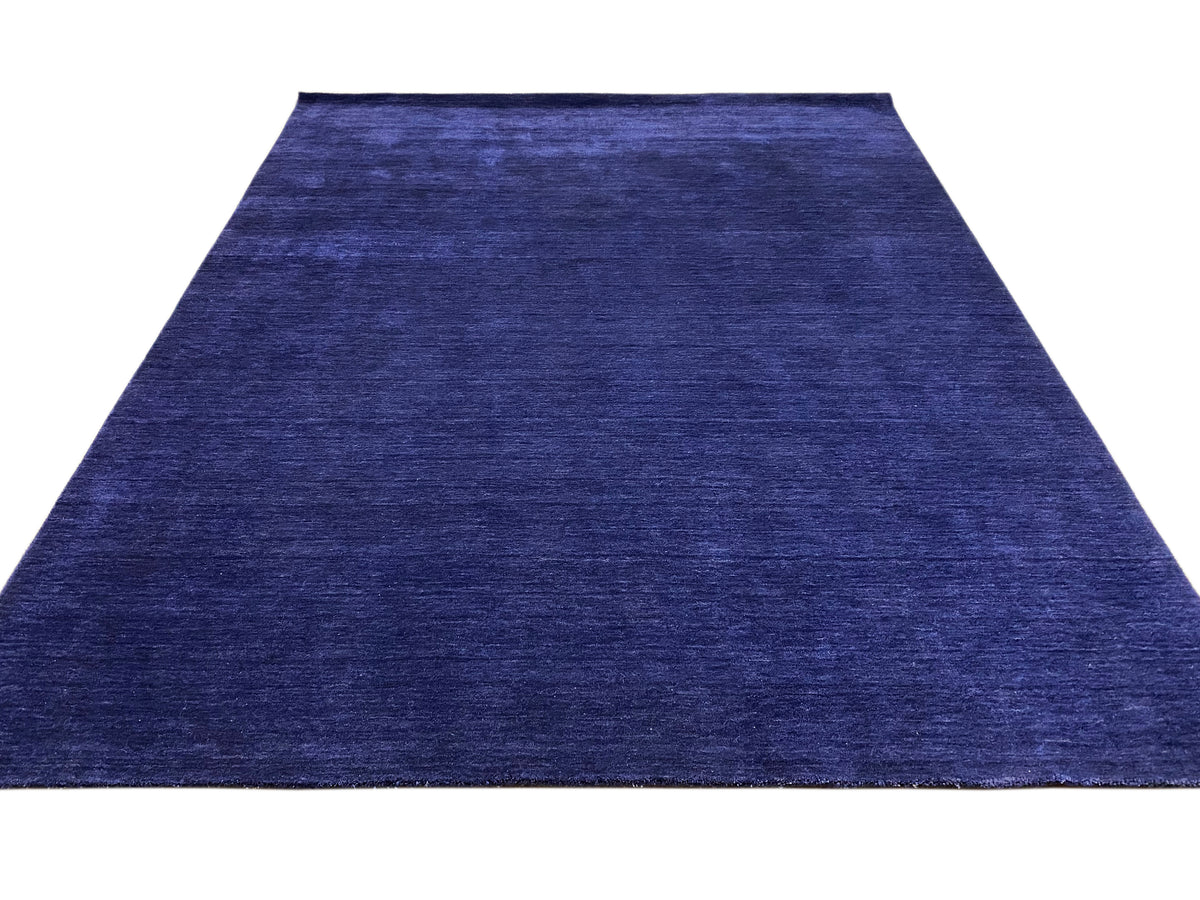 Blue carpet with a narrow pattern repeat and uniform low-pile texture.