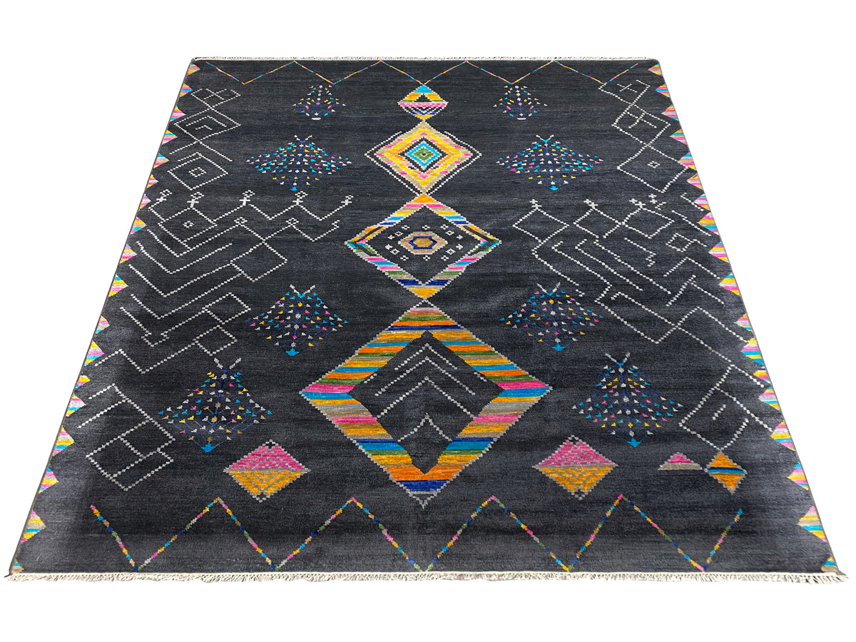 Black designer rug with colorful diamond and lozenge patterns, straight-on view