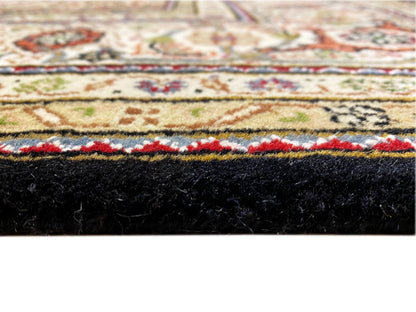 Brown Indo-Tabriz rug detail: pile height and black edge with colored border
