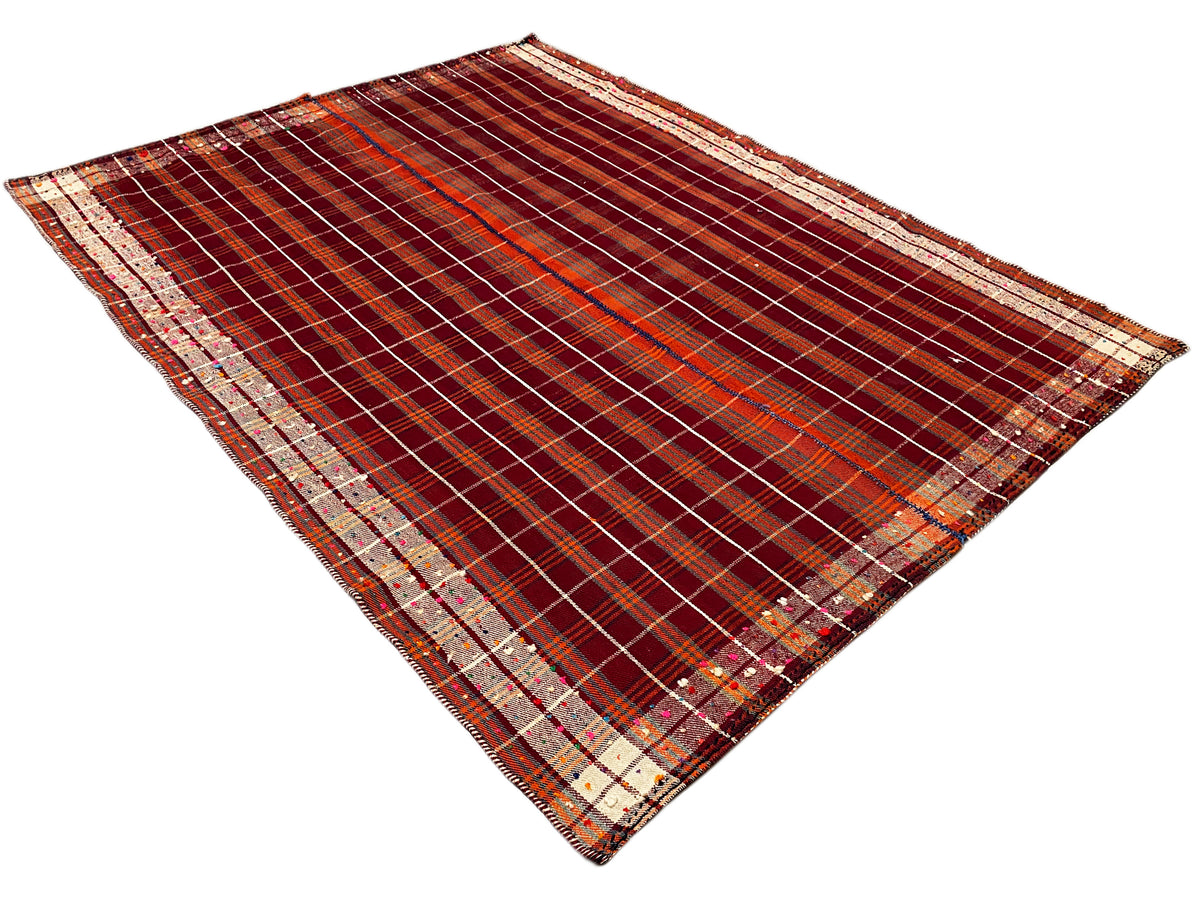 Plaid rug in reddish brown with beige striped borders and a high-contrast pattern