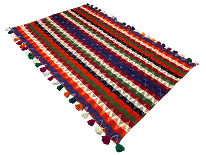 Rectangular rug with wide red, blue, and green stripes, tassels at all four corners