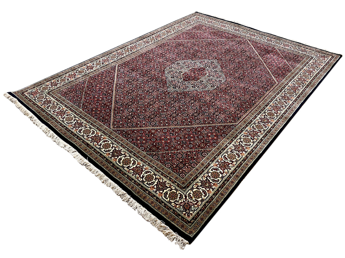 Bidjar rug, red pattern with central medallion, side border and fringes, laid diagonally