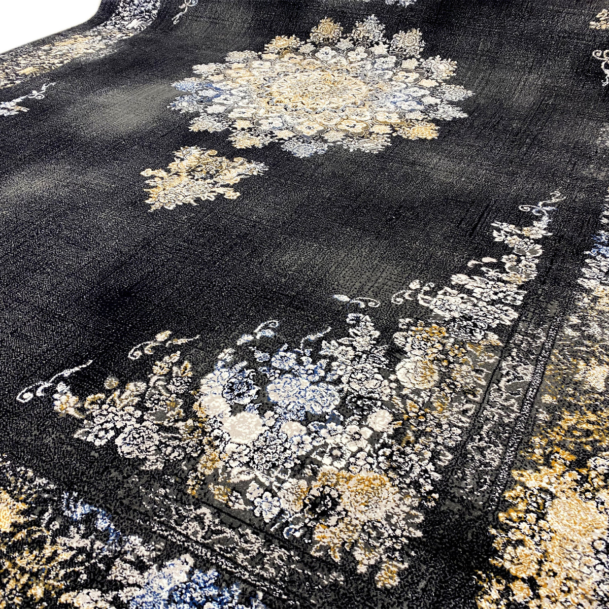 Black rug with a detailed medallion and floral geometric patterns in cream and blue