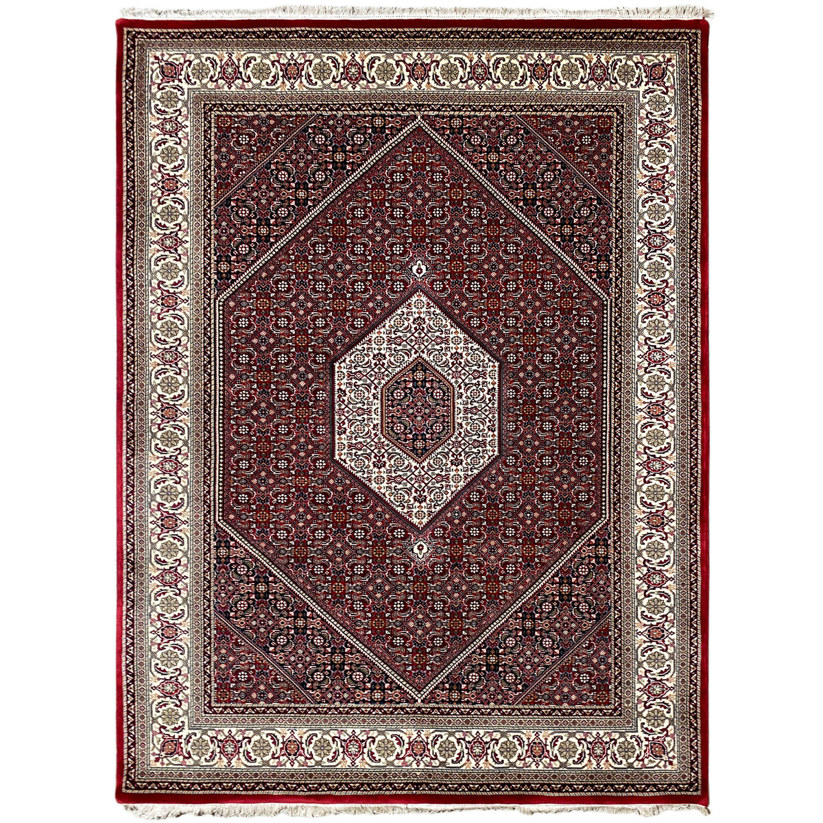 Red rug with a central medallion and surrounding border in cream and dark blue