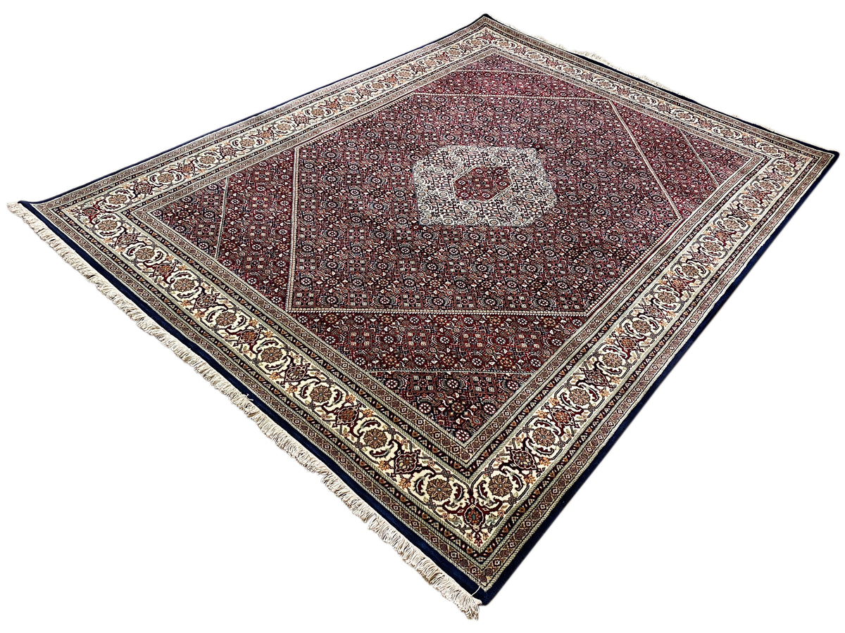 Rug with a wide border, central medallion, and dark reddish-brown background
