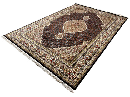 Brown Indo-Tabriz rug laid diagonally, dark center with a beige medallion