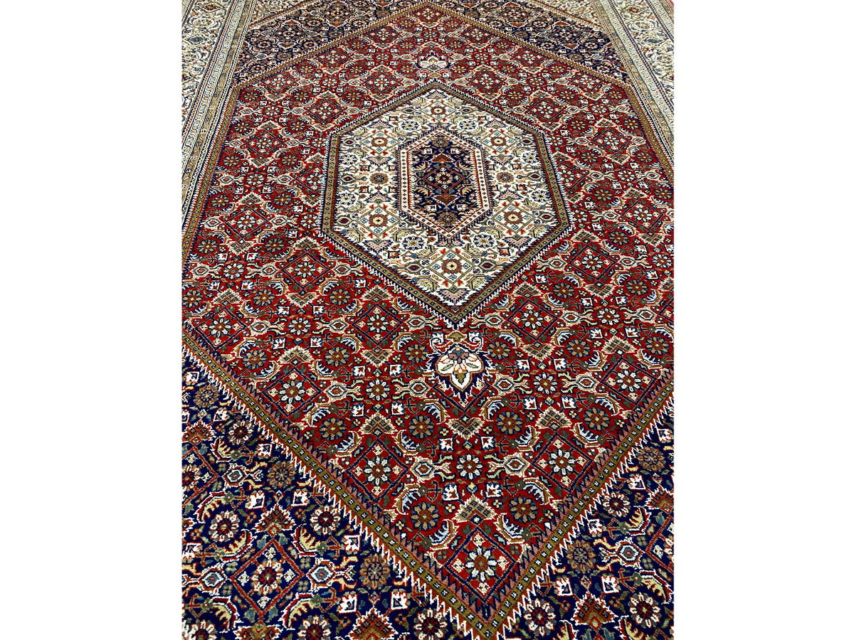 Rug with a red pattern and blue border, central medallion with ornaments
